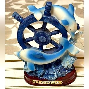 Dolphins/ wheel figurines/ sculpture Florida on pedestal